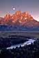 Alpenglow at sunrise as the full moon sets over the Teton Range and Snake River, Grand Teton National Park, Wyoming