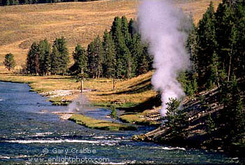 Steam rises from geyser on the Yellowstone River, near Mud Volcano, Yellowstone National Park, Wyoming