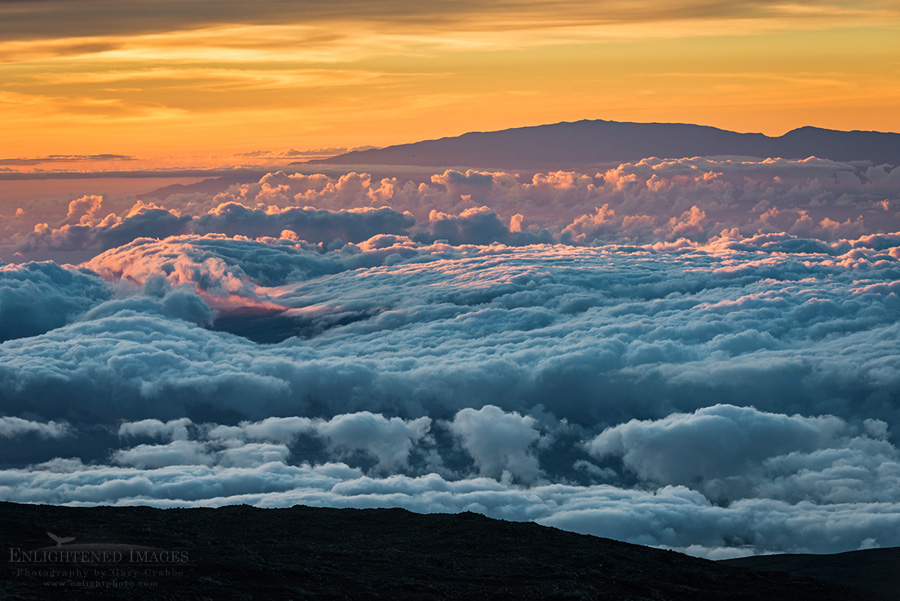 Image: Looking out over a sea of clouds at sunset from the summit of Mauna Kea (13,800') toward Haleakala ( on the island of Maui), Big Island of Hawai'i, Hawaii