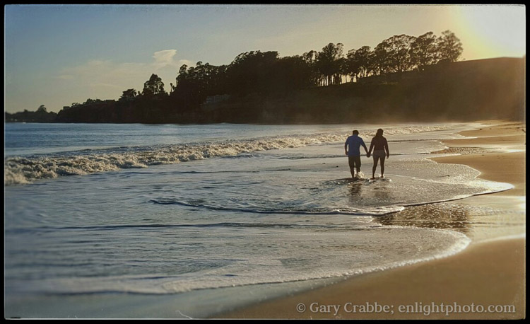 Image: Couple walking on beach at sunset, New Brighton State Park, California