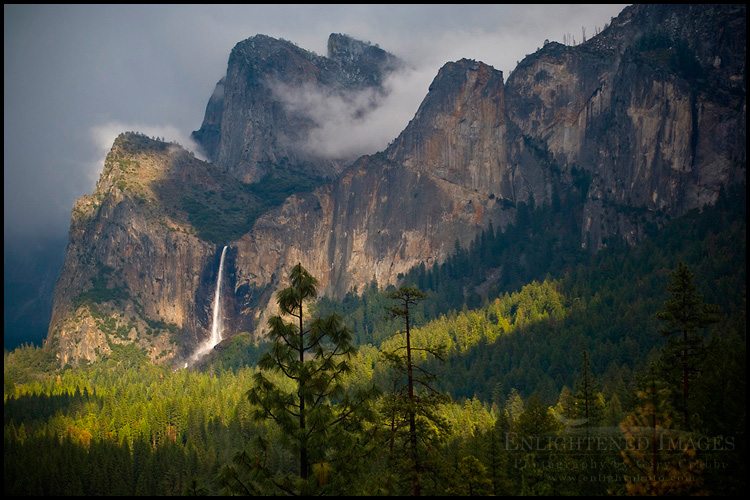 Photo: Sunlight and storm clouds over Bridalveil Fall waterfall and forest, Yosemite Valley, Yosemite National Park, California - ID# vly2-2578