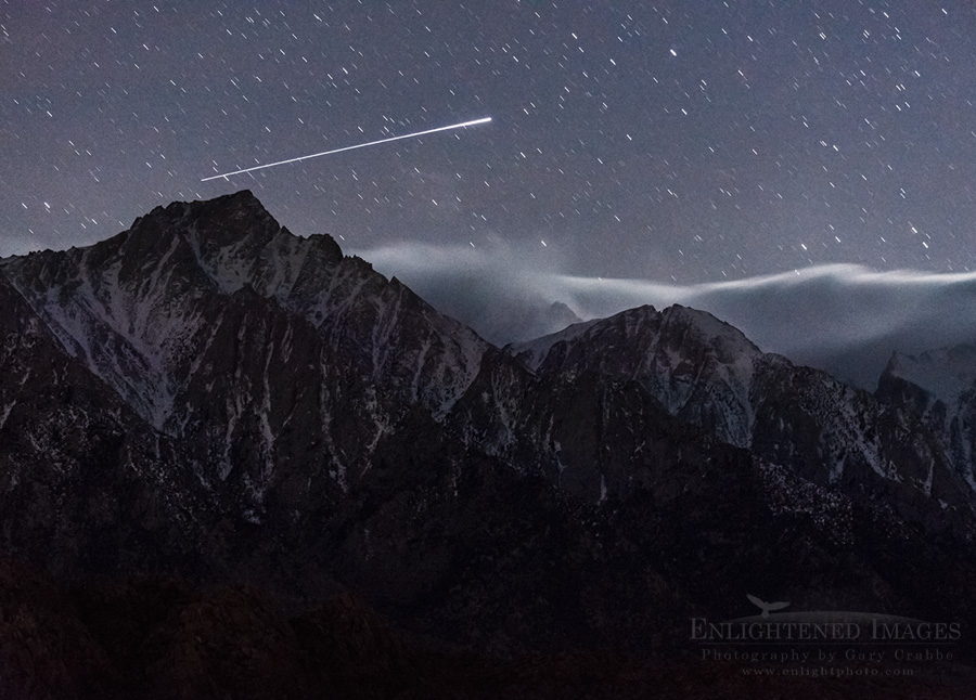 A streak of UFO light in the night sky over the mountains of the Eastern Sierra, near Lone Pine, California