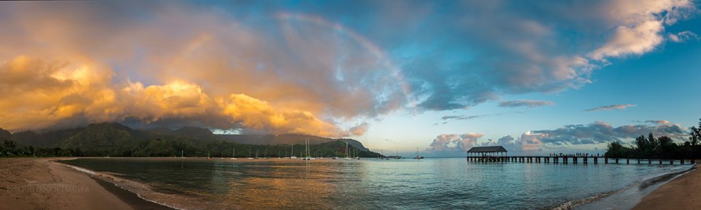 Photo: Panorama of storm clouds and rainbow over Hanalei Bay at sunrise, Kauai, Hawaii