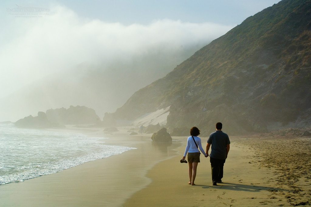 Photo: Couple taking romantic walk together holding hands on sand beach in fog at Pfeiffer Beach, Big Sur Coast, Monterey County, California