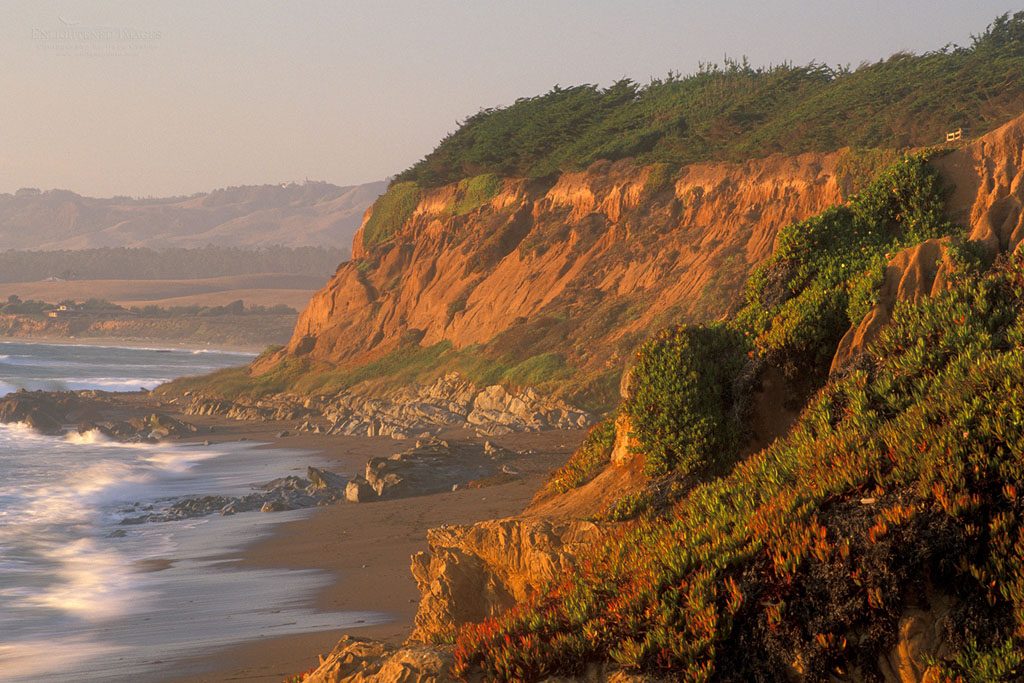 Photo: Sunset light on the coastal bluffs and waves on sand beach at Leffingwell Landing, Cambria, California