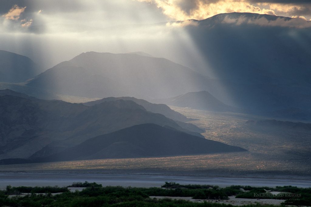 Photo: Sunlight and crepuscular rays through storm clouds on an alluvial fan below the Panamint Mountains, Death Valley National Park, California