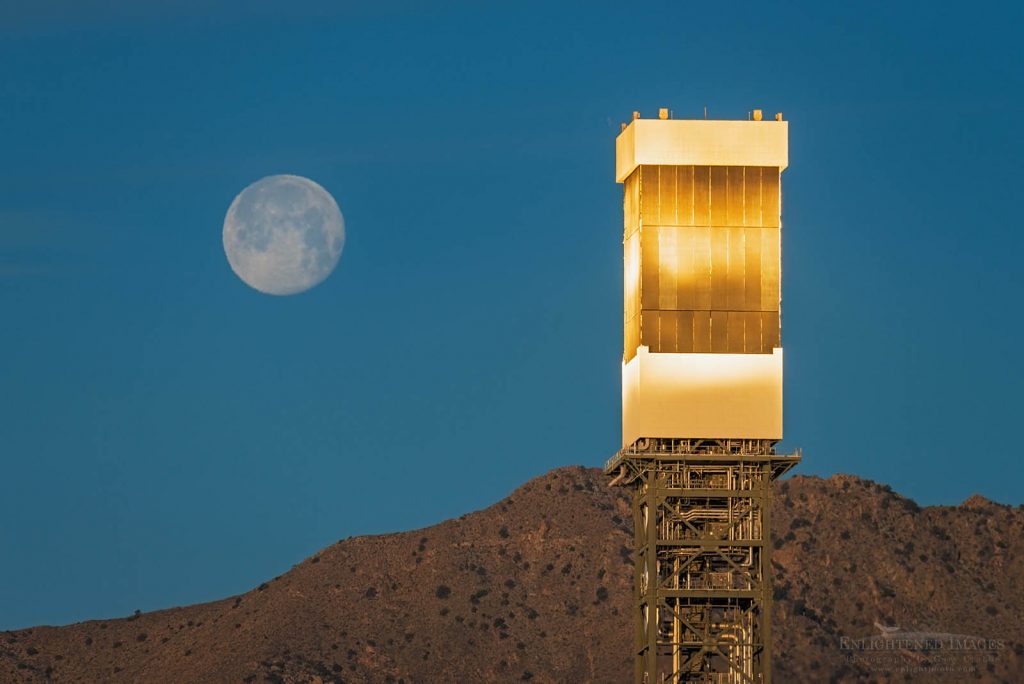Photo: Sunrise light reflected on Solar Array Energy Collector in front of setting full moon, Ivanpah Solar Electric Generating System, Nipton, California
