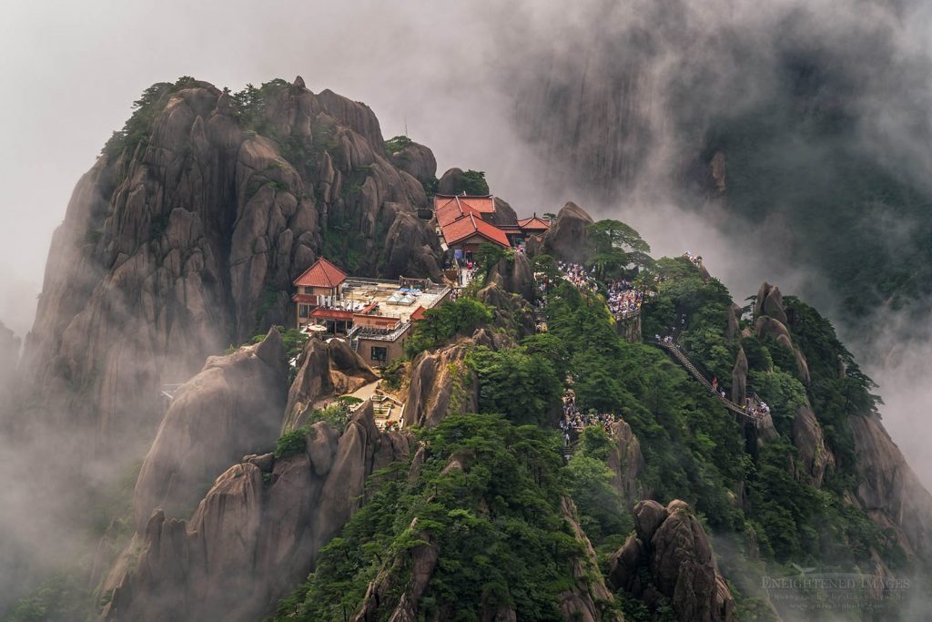 Photo: Tourists and guest house in rock outcrop and mist seen from Lotus Peak, in the Huangshan Mountains (Yellow Mountain), Anhui Province, China