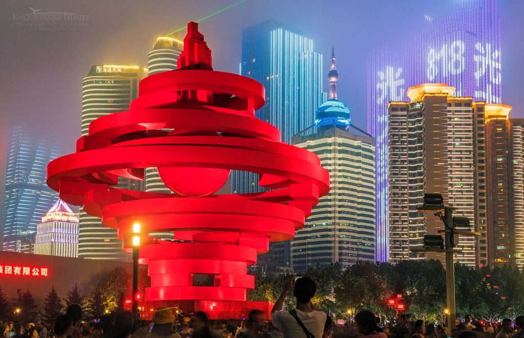 Photo: The Winds of May sculpture in Wusi Square (May 4th Square) and buildings lit up at night in downtown Qingdao, Shandong Province, China
