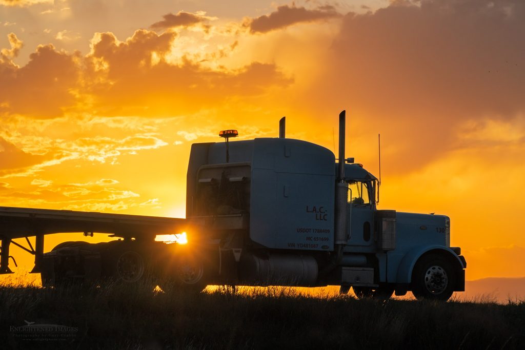 Photo: Big Rig tractor and flatbed trailer at sunrise in McPherson, Kansas