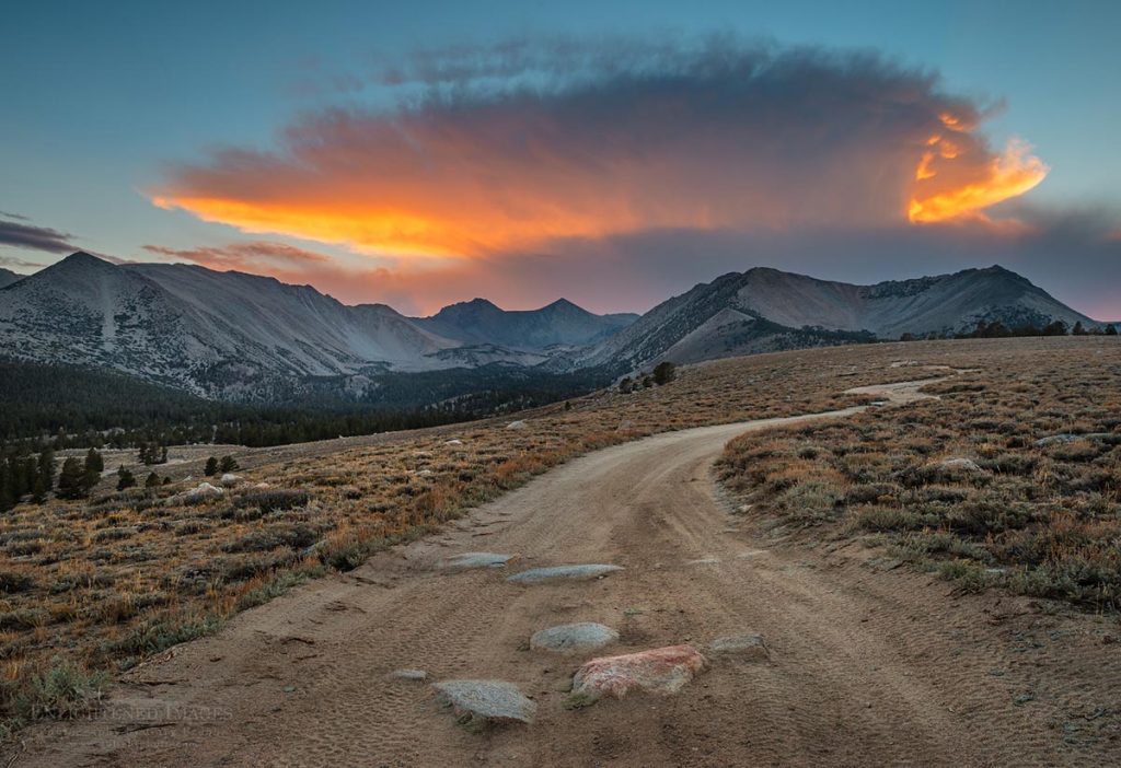 Photo: Sunset light on cloud over mountains and dirt road in the Inyo National Forest, Inyo County, Eastern Sierra, California
