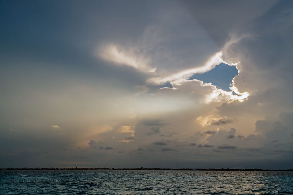 Photo: Storm clouds and sunbeams over the water offshore from Cancun, Yucatan Peninsula, Quintana Roo, Mexico