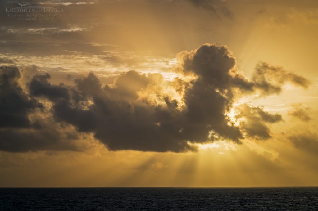 Photo Picture of "Rise of the Mayan Sun God," Crespuscular Rays (Sunbeams) behind cloud at sunrise over the Caribbean Sea from Cancun, Quintana Roo, Yucatan Peninsula, Mexico