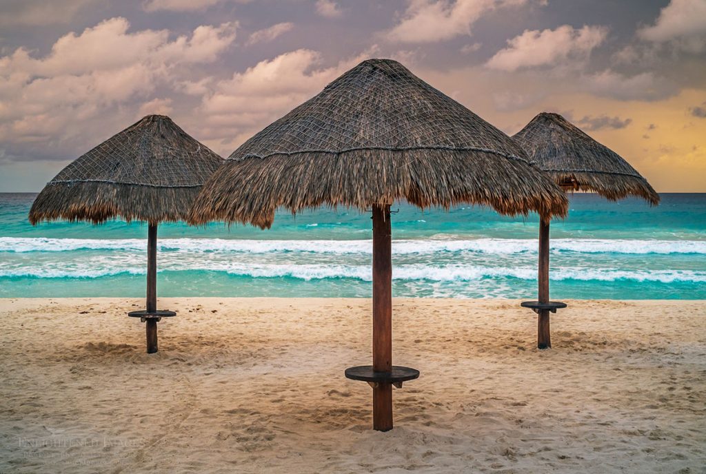 Photo picture of Beach palapas on a stormy sunset at Playa Delfinas, Hotel Zone of Cancun, Quintana Roo, Yucatan Peninsula, Mexico