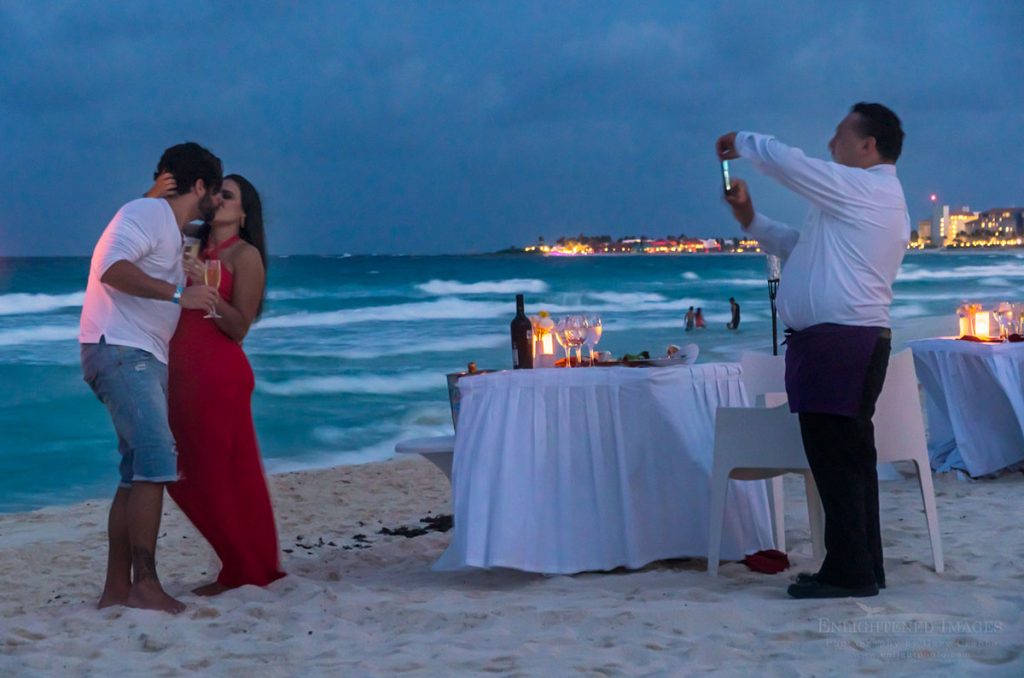 Photo: Waiter takes a romantic photo of couple having dinner on the beach at Playa Delfinas, Cancun, Maya Riviera, Yucatan Peninsula, Quintana Roo, Mexico